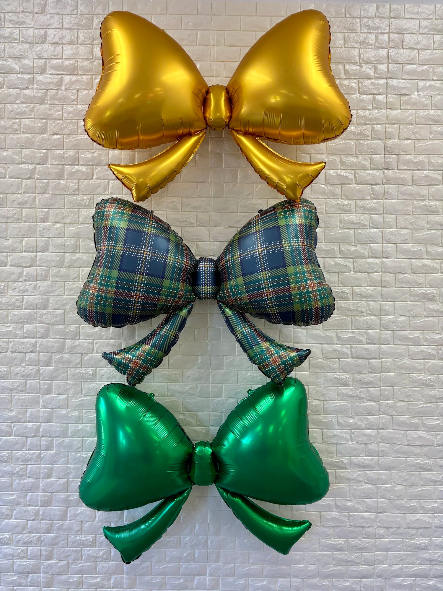 Plaid bow balloon 40 inches displayed as holiday party décor with festive accents