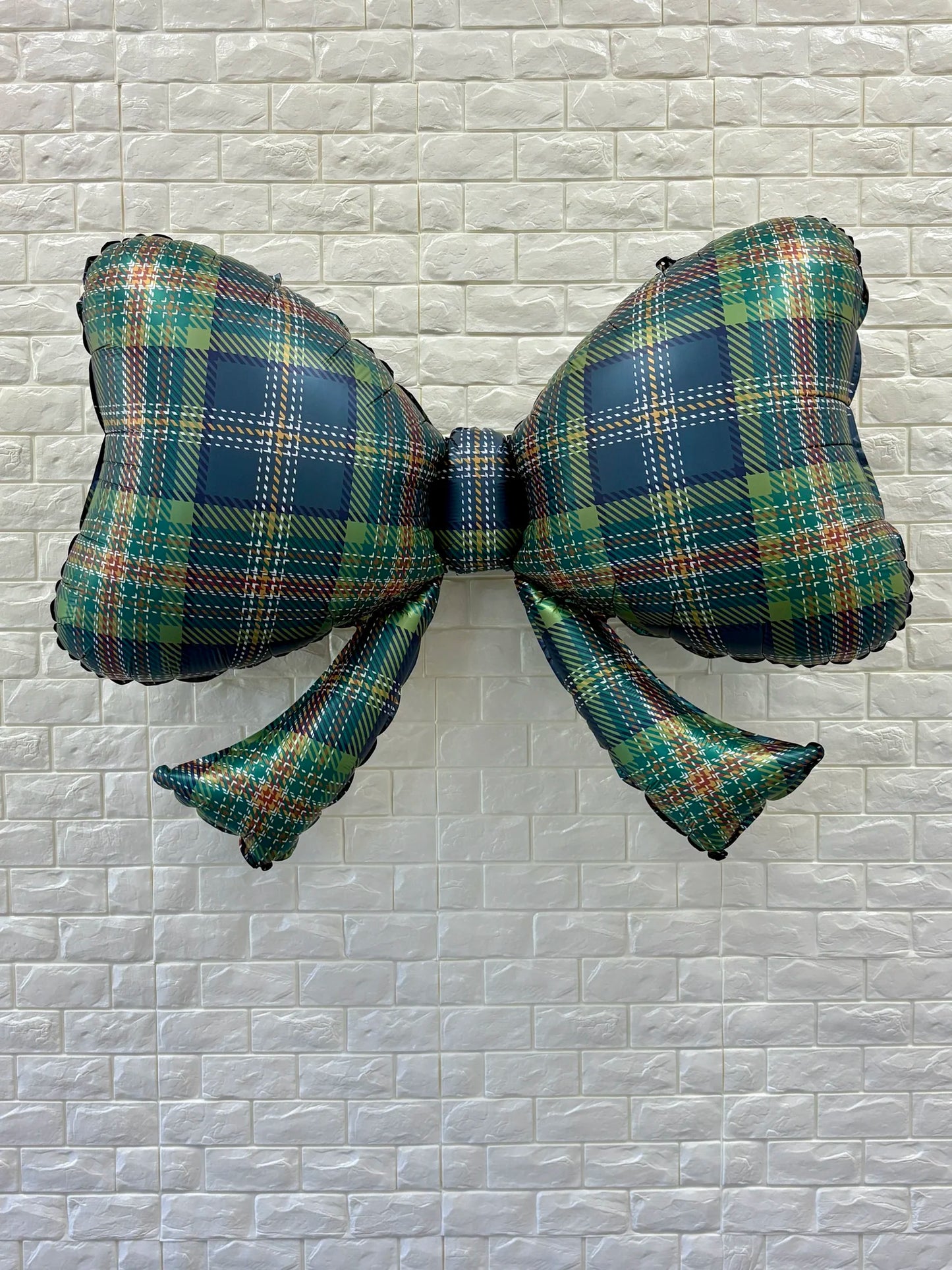 Full view of 40-inch plaid bow balloon, a large festive decoration for parties and events