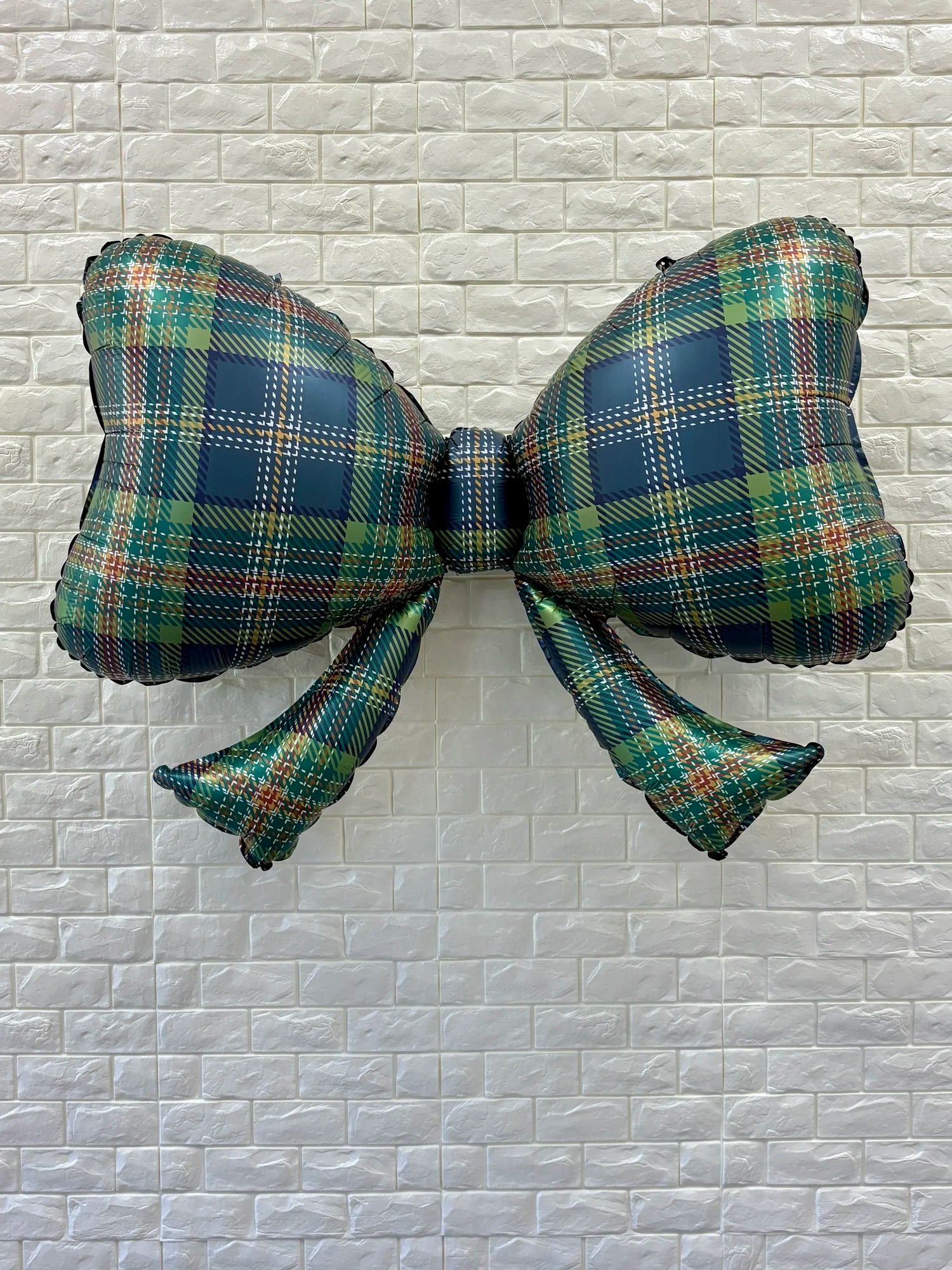 Full view of 40-inch plaid bow balloon, a large festive decoration for parties and events